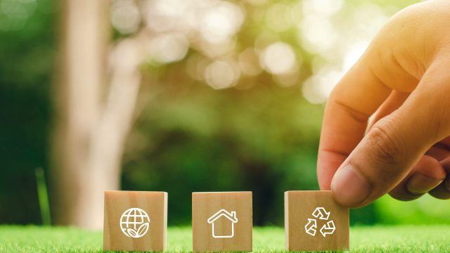 wooden block icon with hand touching With technology joining hands with environment icons through the connection of the environment.